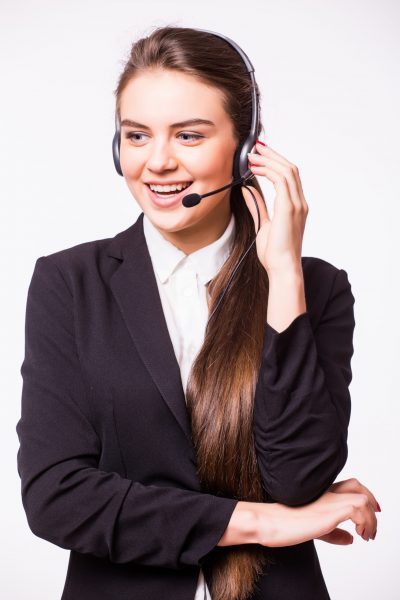 Portrait of happy smiling cheerful beautiful young customer support phone operator in headset, isolated over white background